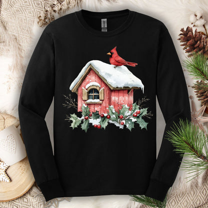 Black Gildan long sleeve tee with a watercolor red cardinal on a snowy birdhouse with holly.