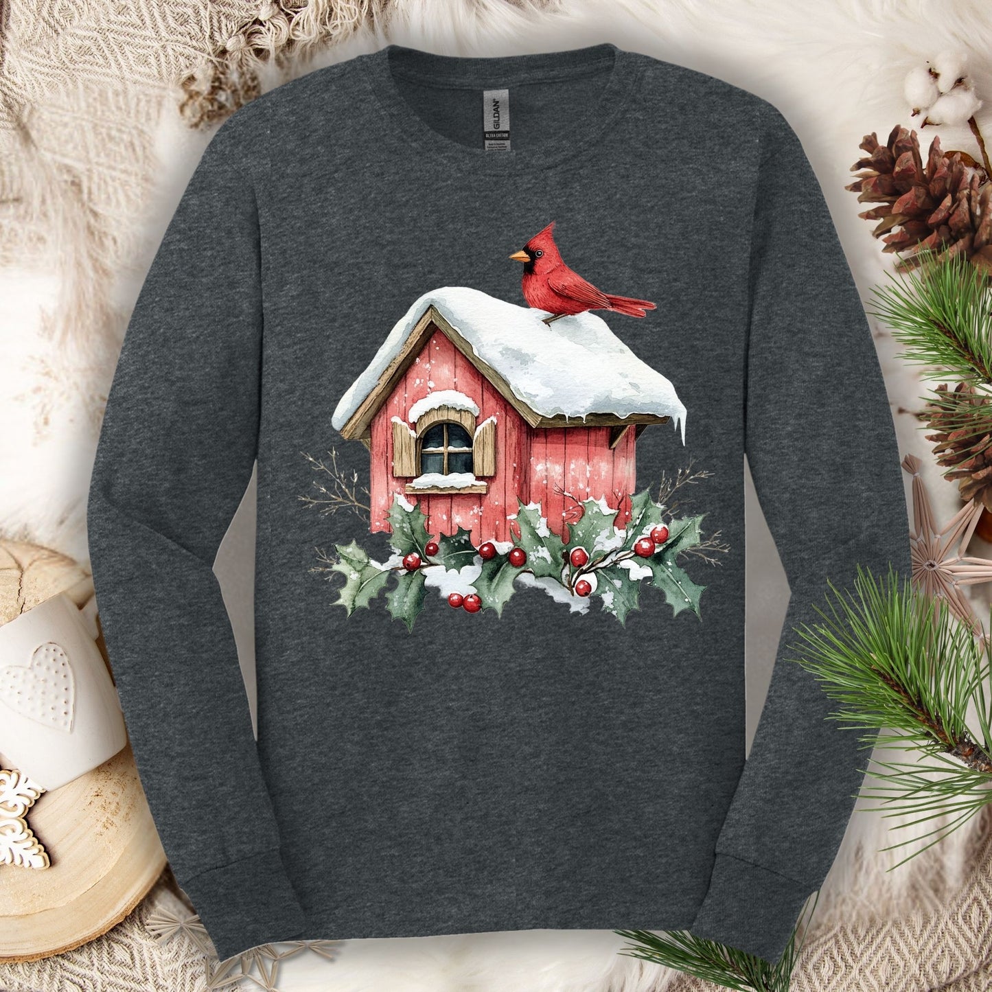 Dark Heather long sleeve tee with a watercolor red cardinal on a snowy rustic birdhouse with holly.