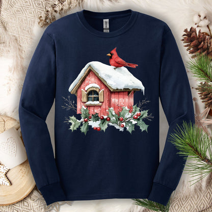 Navy long sleeve tee with a watercolor red cardinal on a snowy rustic birdhouse with holly.
