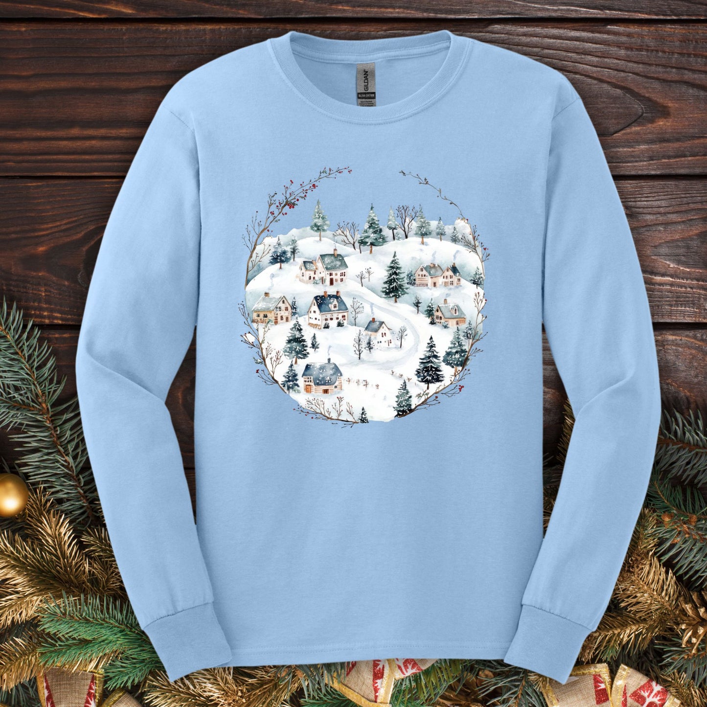 Light blue Gildan long sleeve tee with a watercolor Nordic winter village design.