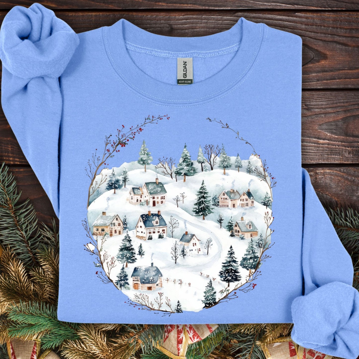 Carolina Blue Gildan fleece sweatshirt with a watercolor Nordic winter village design.