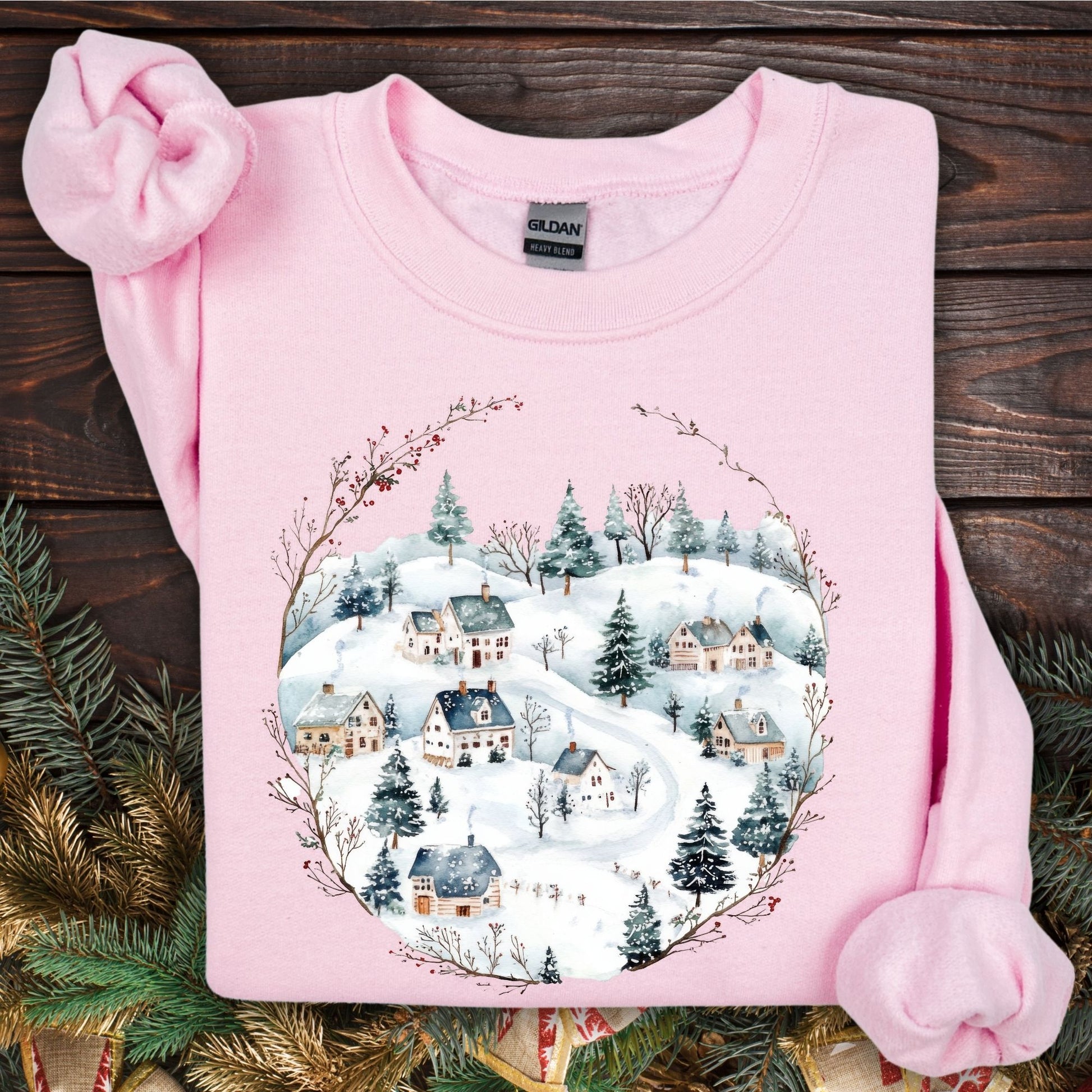 Light pink Gildan fleece sweatshirt with a watercolor folk-art snowy Nordic village design.