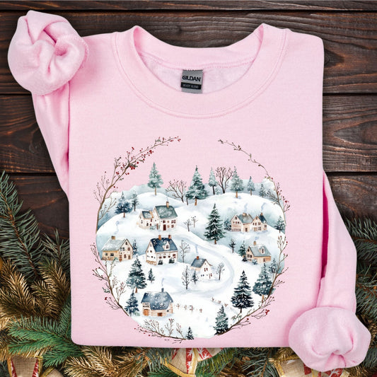 Light pink Gildan fleece sweatshirt with a watercolor folk-art snowy Nordic village design.
