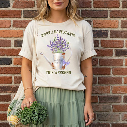 young woman wearing a t-shirt with a plant-themed design against a brick wall.