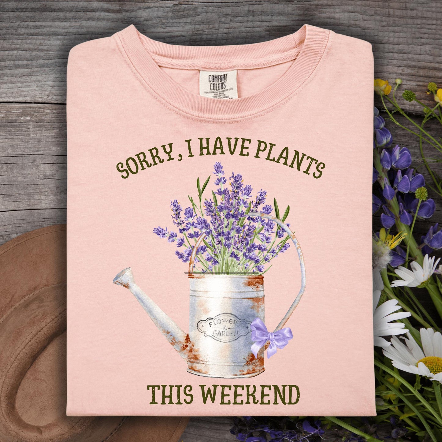 Peachy Comfort Colors t-shirt with "Sorry, I Have Plants This Weekend" and a vintage watering can with lavender.