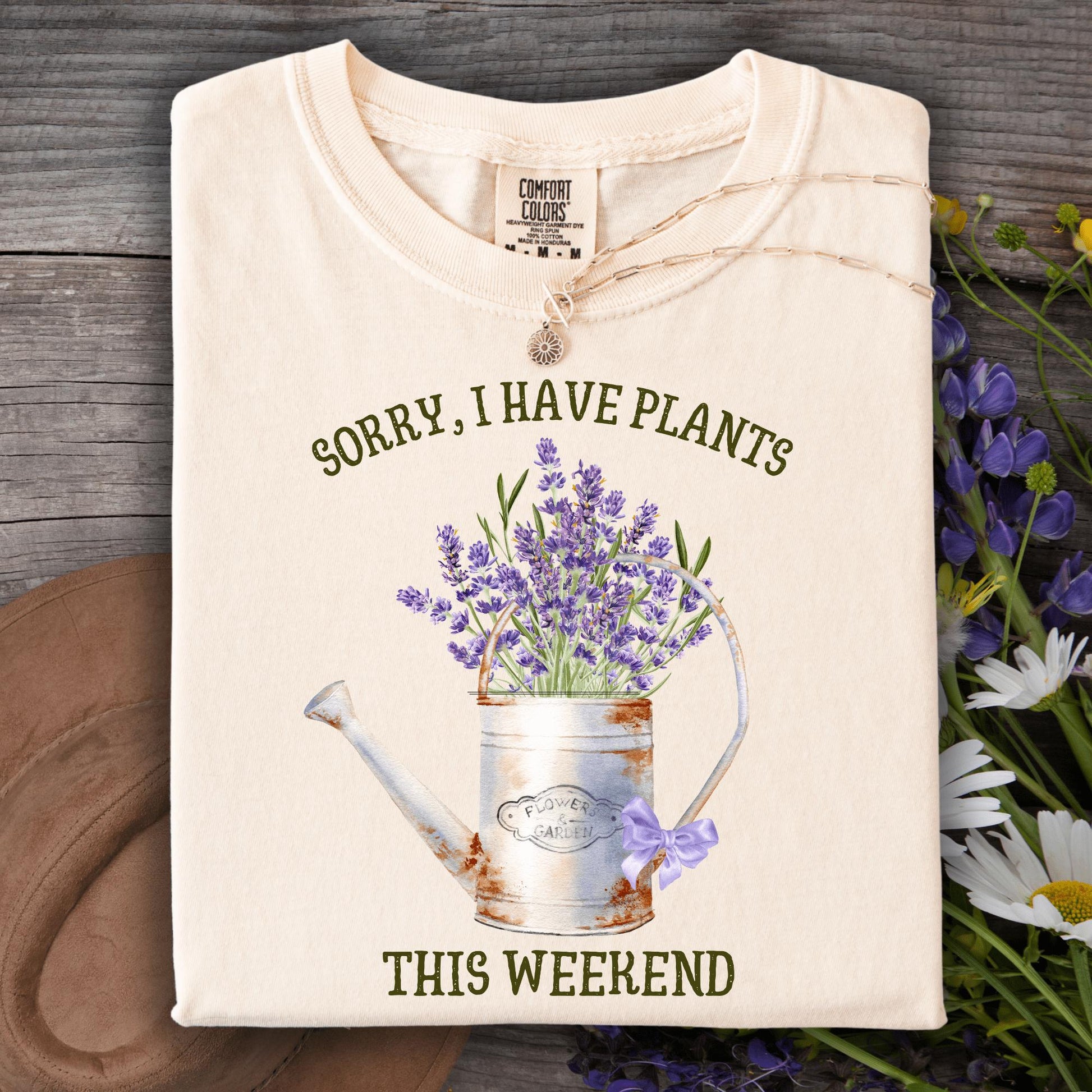 Ivory "Sorry I Have Plants" tee with a vintage watering can and watercolor lavender.