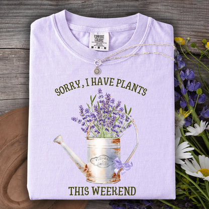 Orchid Comfort Colors tee with "Sorry, I Have Plants This Weekend" text and a vintage watering can with lavender.