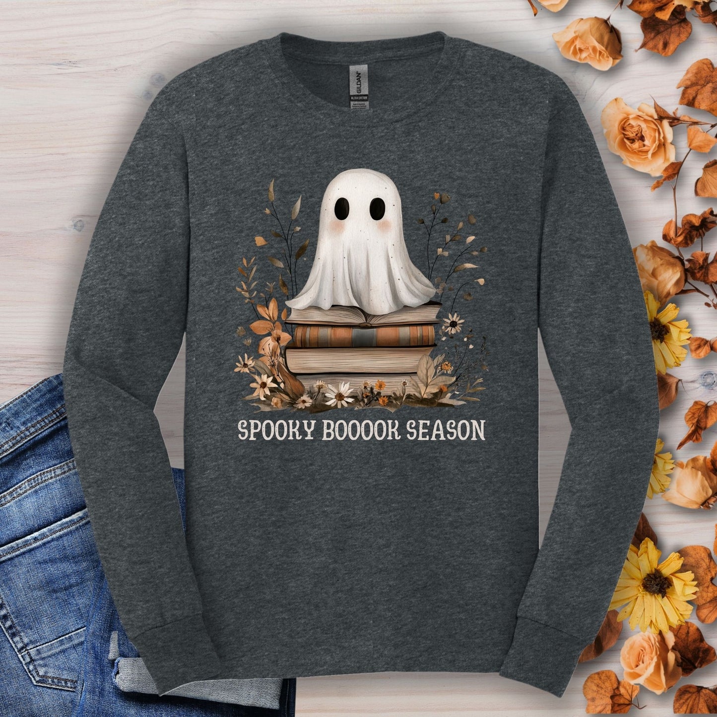 Dark Heather Gildan long sleeve tee with a boho ghost on books, wildflowers, and "Spooky Boooook Season" text.