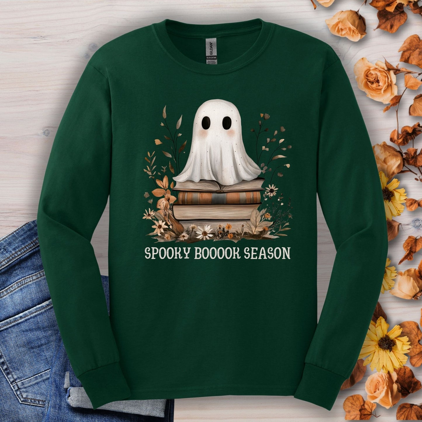 Forest Green Gildan long sleeve tee with a boho ghost on books, wildflowers, and "Spooky Boooor Season" text.