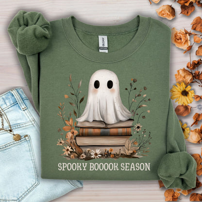 Military Green Gildan sweatshirt with a boho ghost on vintage books, autumn wildflowers, and "Spooky Booook Season" text.
