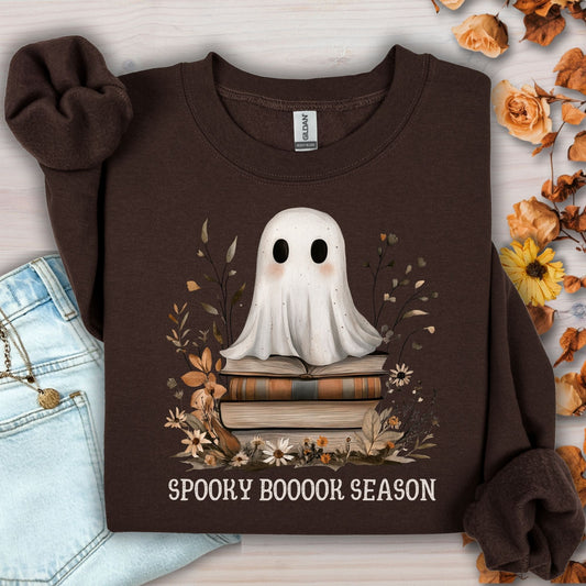 Dark chocolate Gildan crewneck sweatshirt with a boho ghost on vintage books and autumn wildflowers.
