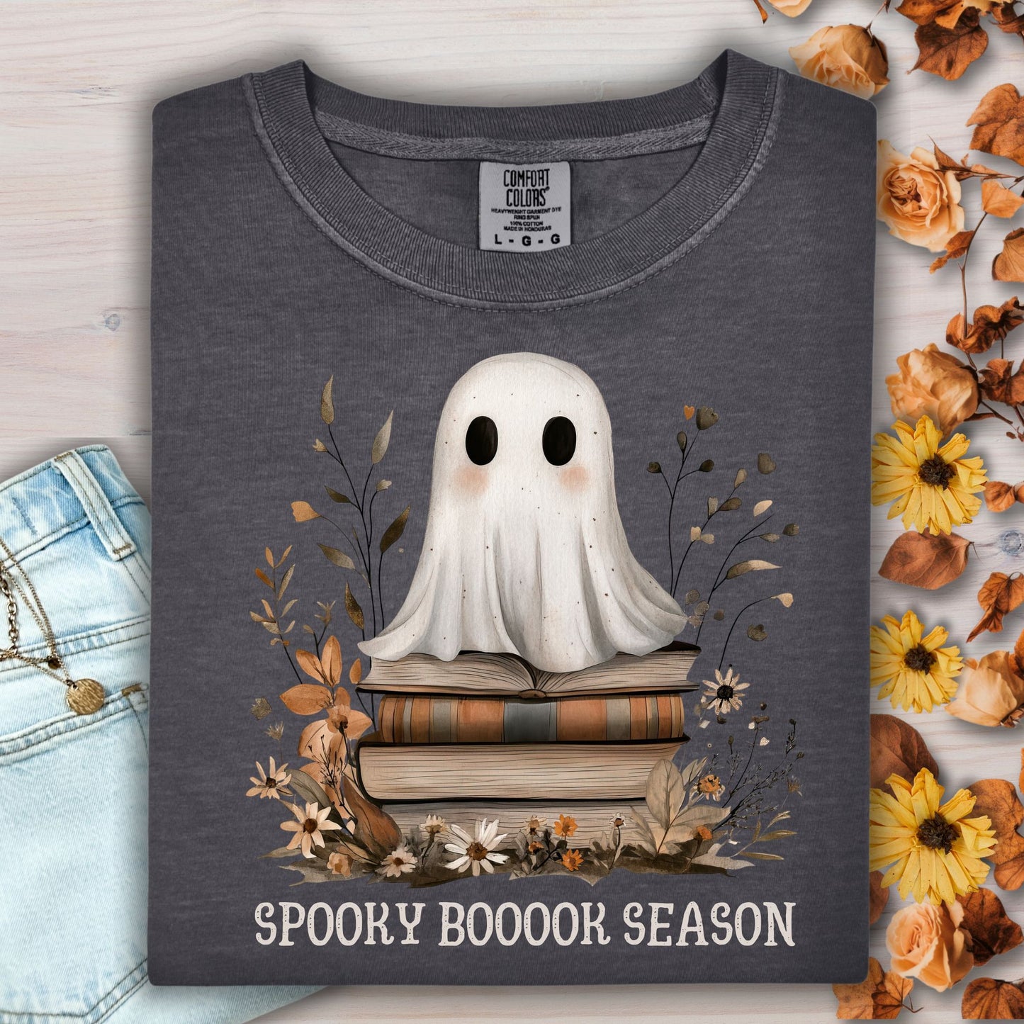 Pepper Comfort Colors tee with a cute ghost on vintage books and "Spooky Booook Season" text.