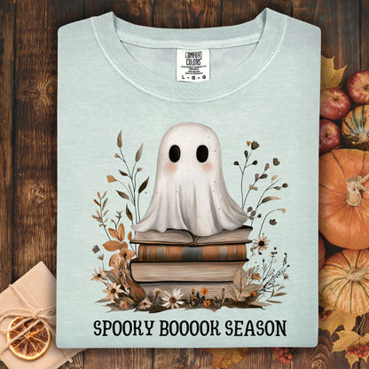 Bay Comfort Colors tee with a cute ghost on vintage books and "Spooky Boooook Season" text.