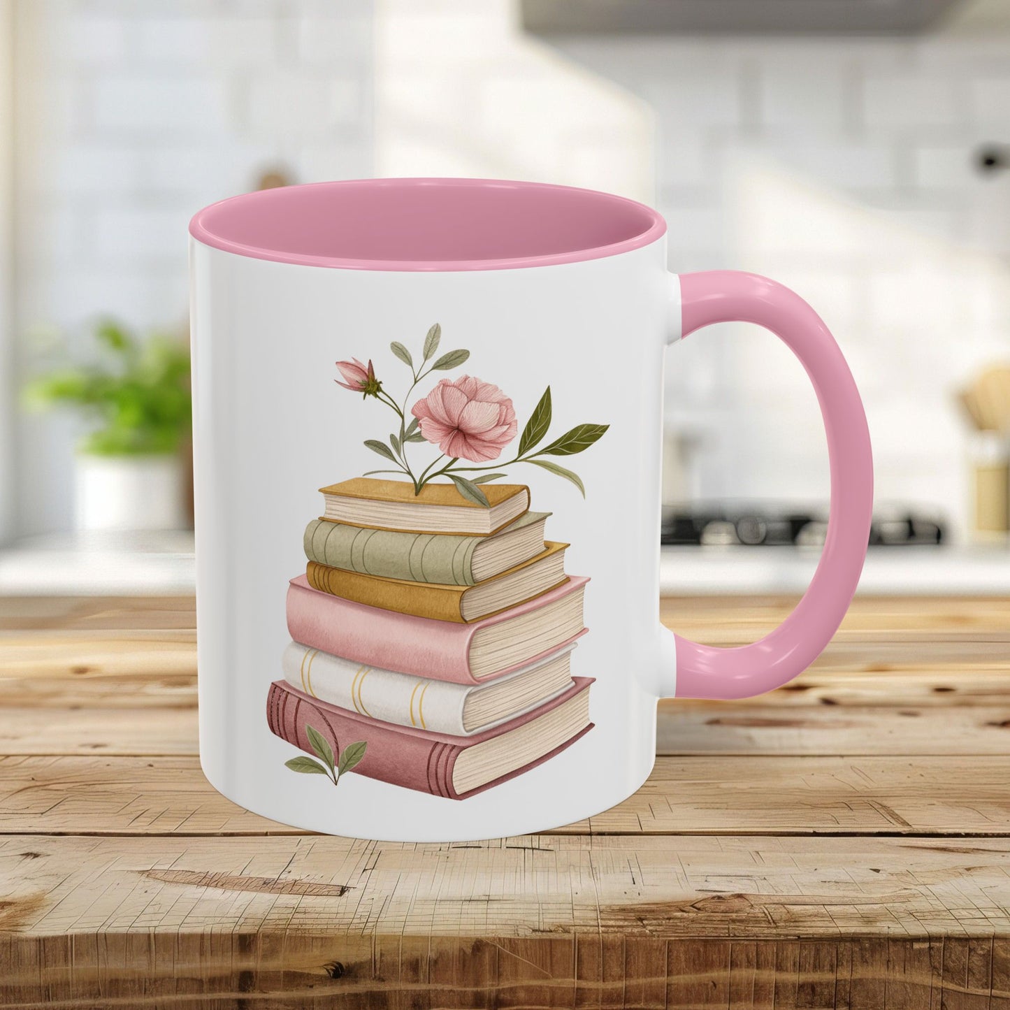 White 11oz ceramic mug with pink handle and interior, featuring a watercolor stack of books and floral accents.