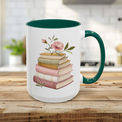 15oz glossy white ceramic mug with green handle/interior, featuring a watercolor stack of books and pink floral accents.