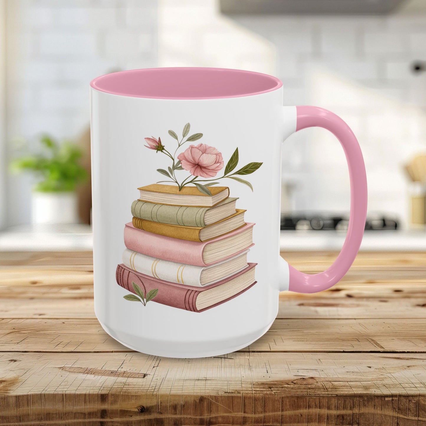 15oz white ceramic mug with pink handle and interior, featuring a watercolor stack of books and floral accents.