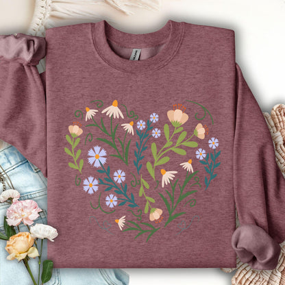 Maroon sweatshirt with a heart-shaped floral design of daisies, tulips, and bell flowers with green vines.