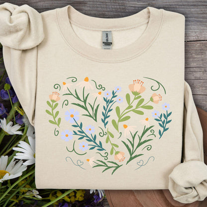 Sand sweatshirt with a heart-shaped botanical design of wildflowers, leaves, and curling vines.