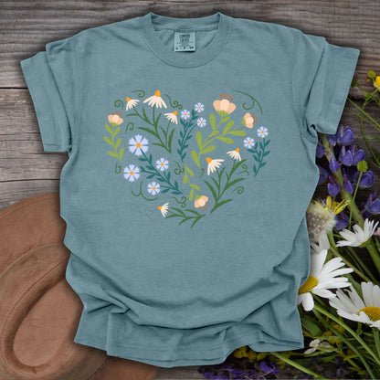 Ice Blue S t-shirt with a heart-shaped botanical design of wildflowers, foliage, and decorative swirls.