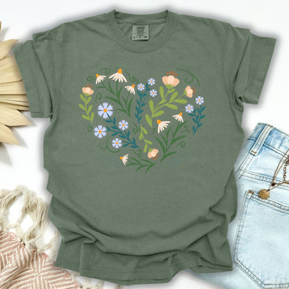 Moss S T-shirt with a heart-shaped botanical design of wildflowers, bell-shaped blooms, and green foliage.