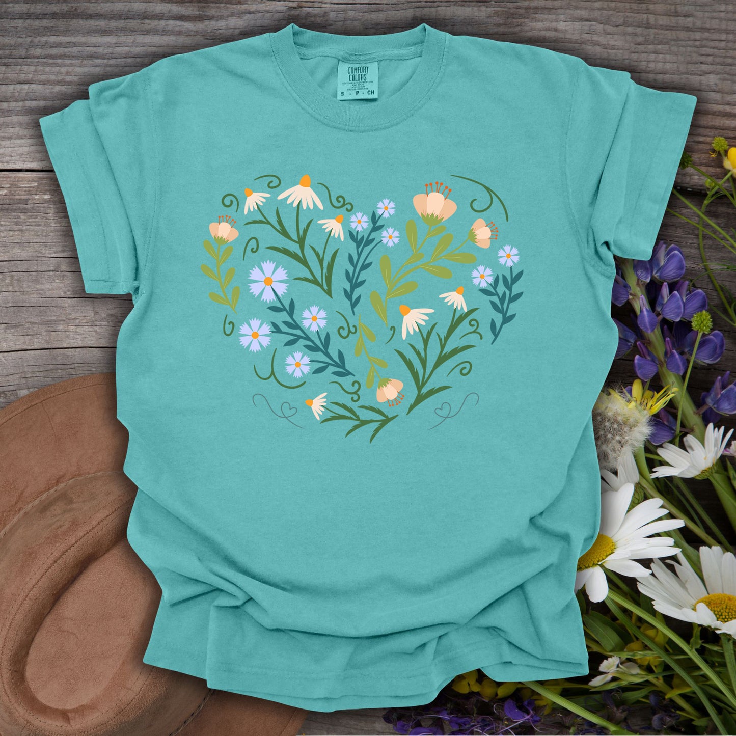 Seafoam S t-shirt with a heart-shaped botanical wildflower design and green foliage.