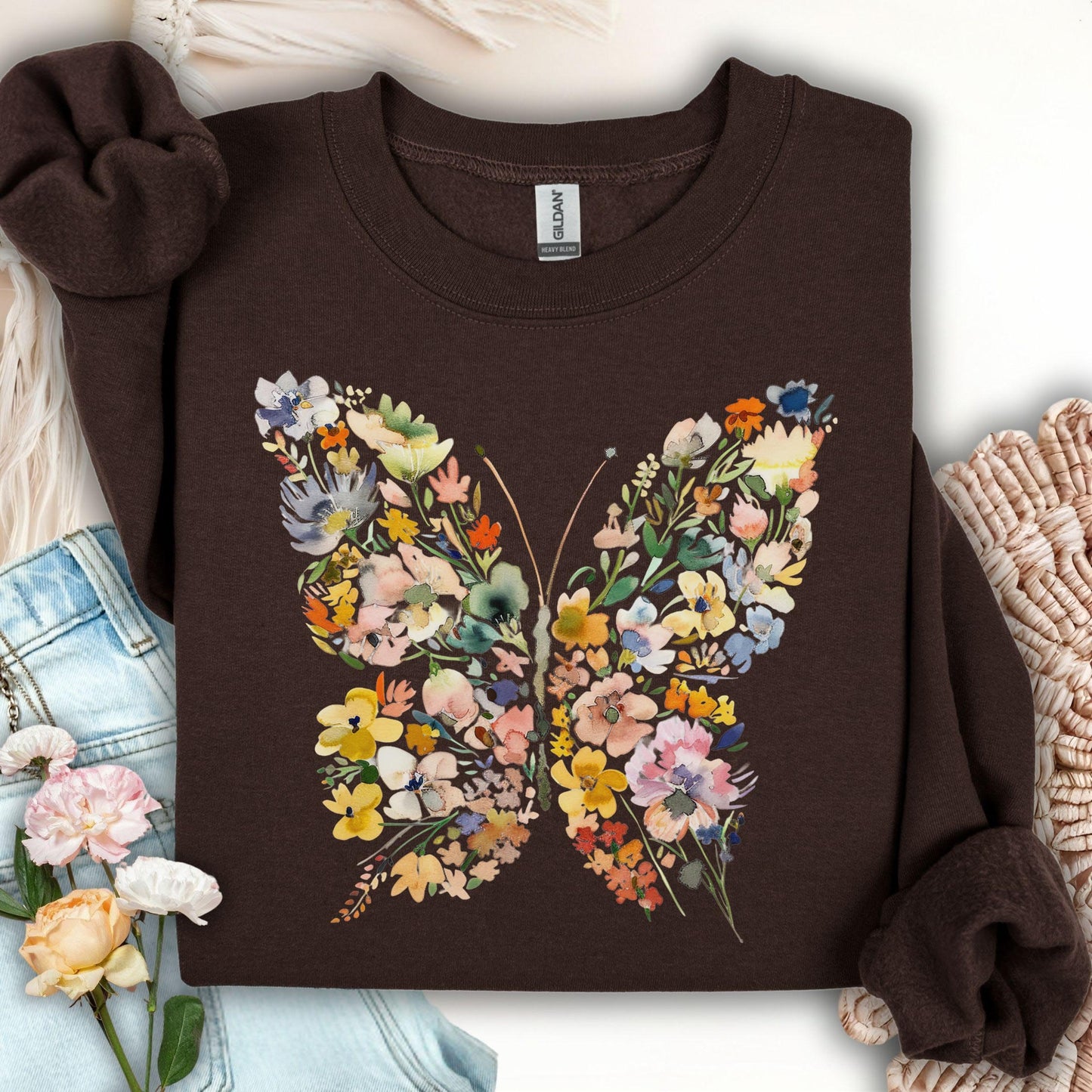 Dark chocolate sweatshirt with a large, colorful butterfly design made of watercolor-style flowers and leaves.
