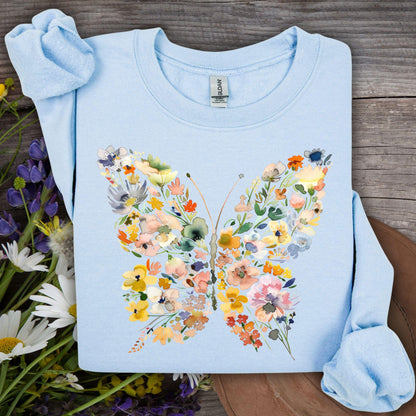 Light blue sweatshirt with a watercolor-style butterfly design made of colorful flowers and leaves.