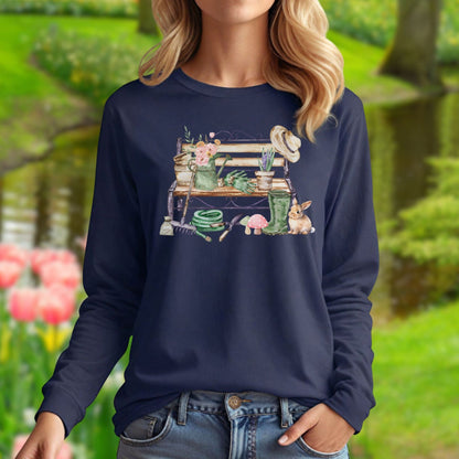 Navy long sleeve tee with a watercolor garden bench, tools, flowers, and a rabbit design.