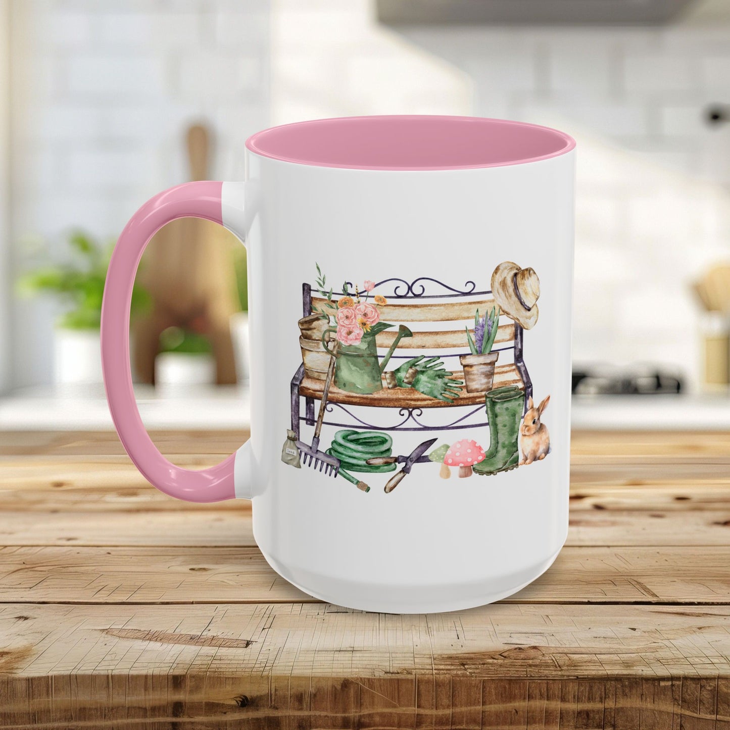 White ceramic mug with pink handle and interior, featuring a watercolor garden bench design.