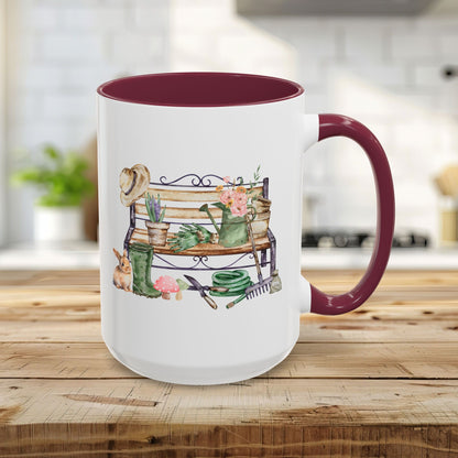 15oz white ceramic mug with maroon handle/interior, featuring a watercolor garden bench design.