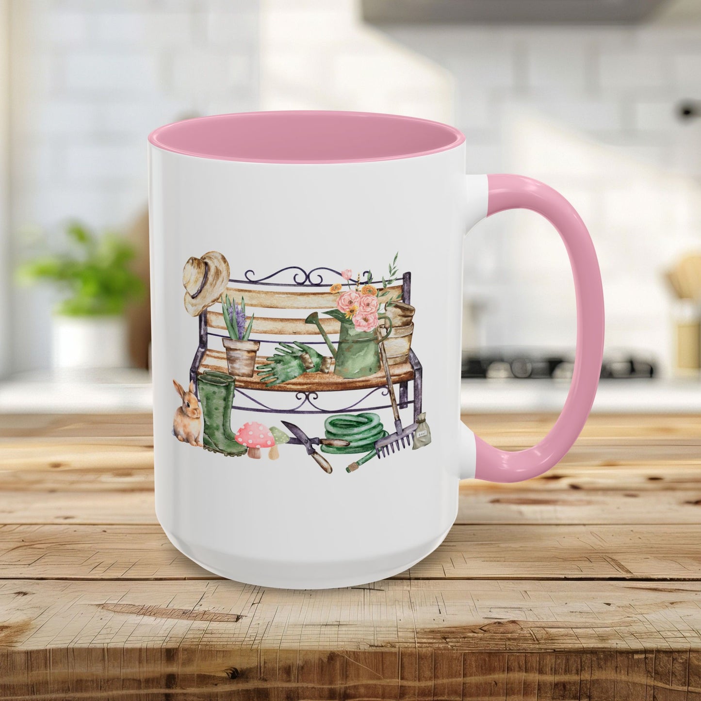 15oz ceramic mug with pink handle/interior, featuring a watercolor garden bench design with tools and a bunny.