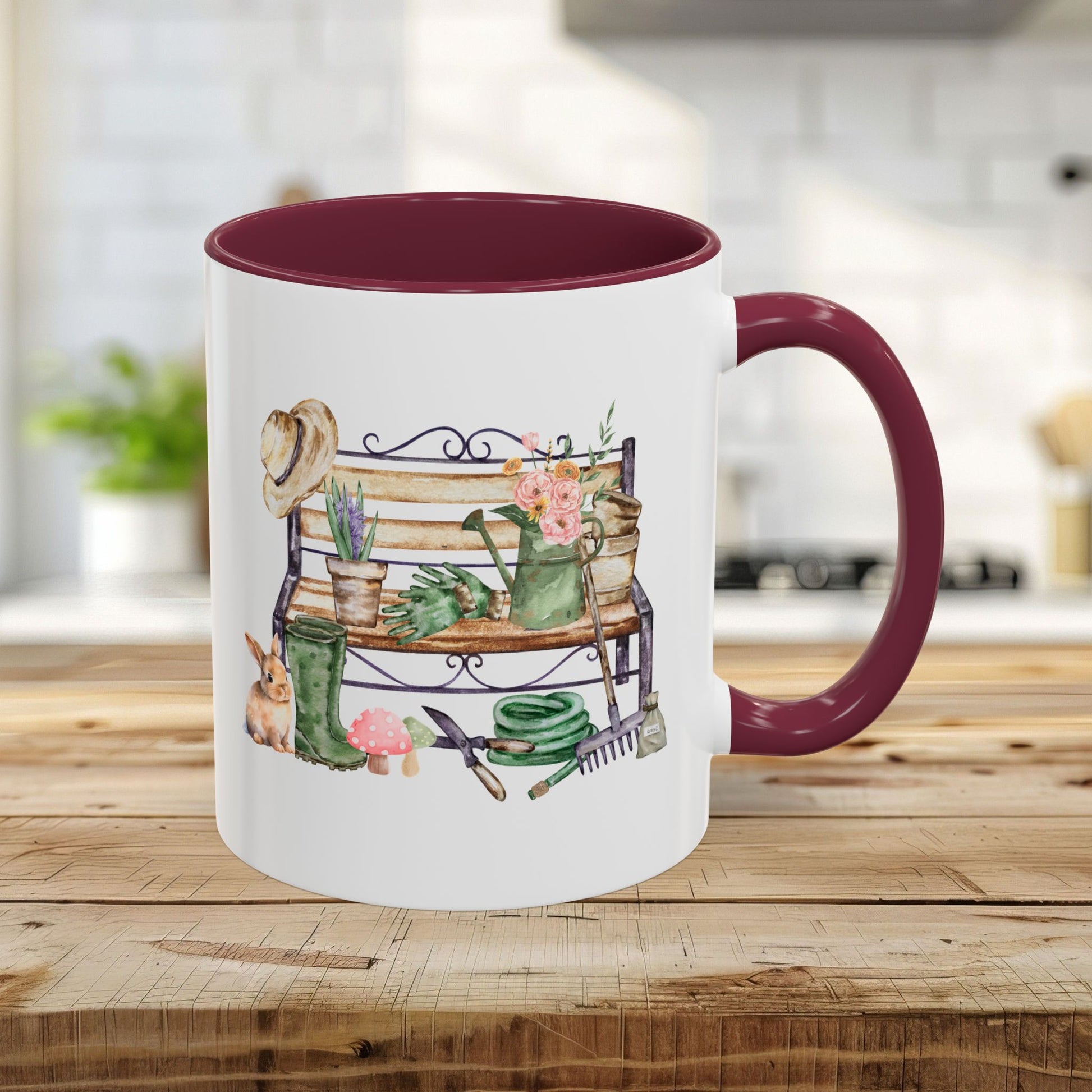 White ceramic mug with a maroon handle and interior, featuring a watercolor garden bench design.