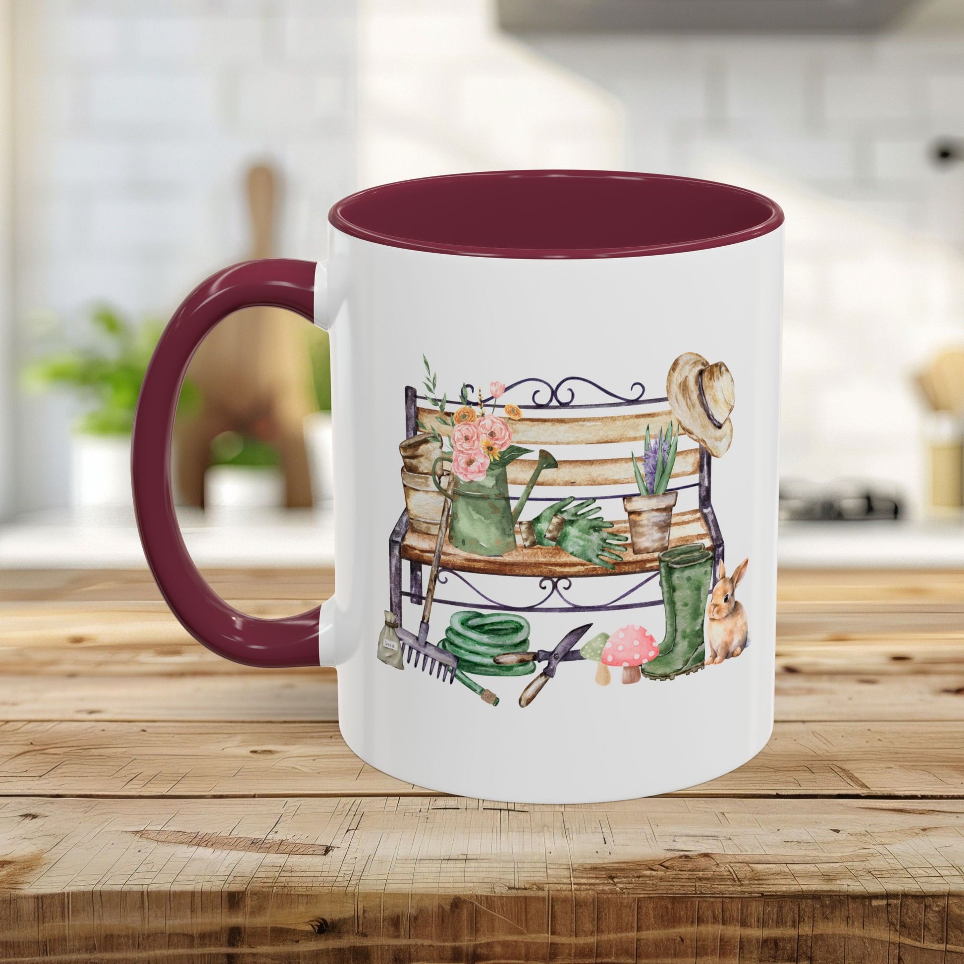 White ceramic mug with a maroon handle and interior, featuring a watercolor garden bench design.