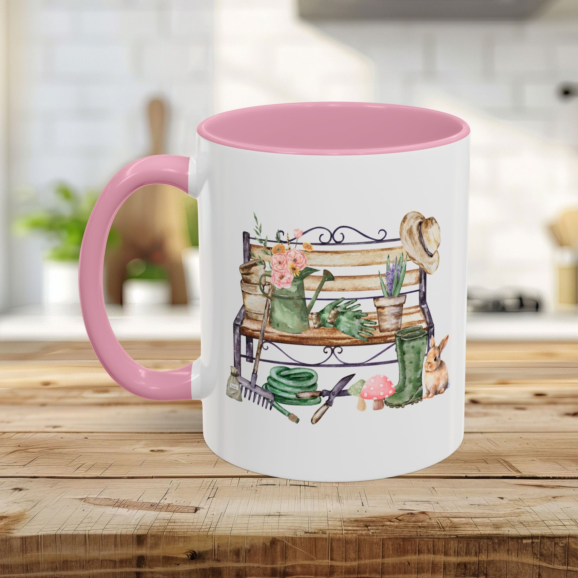 White ceramic mug with pink handle and interior, featuring a watercolor garden bench design.