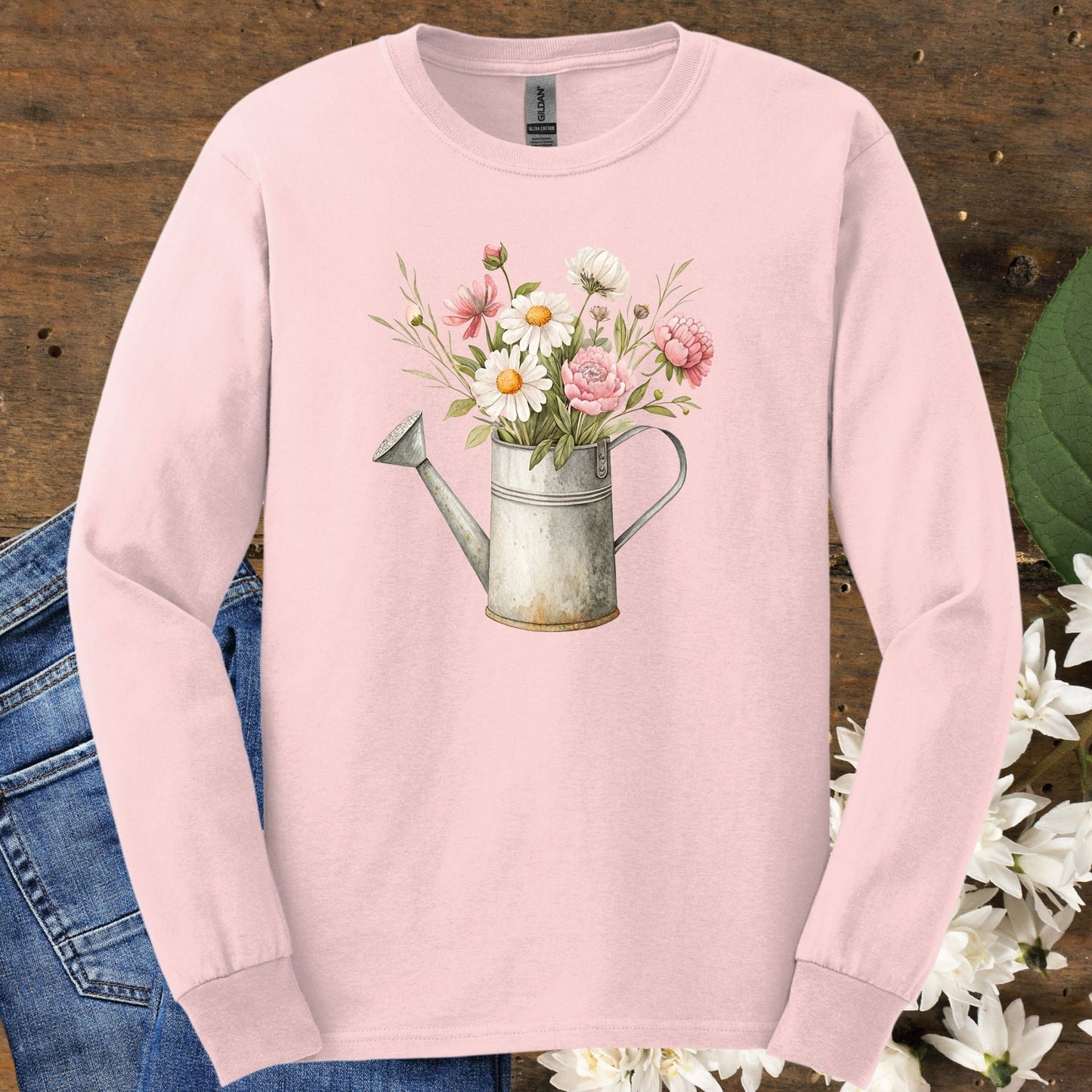 Light pink long sleeve tee with a vintage watering can and floral illustration.
