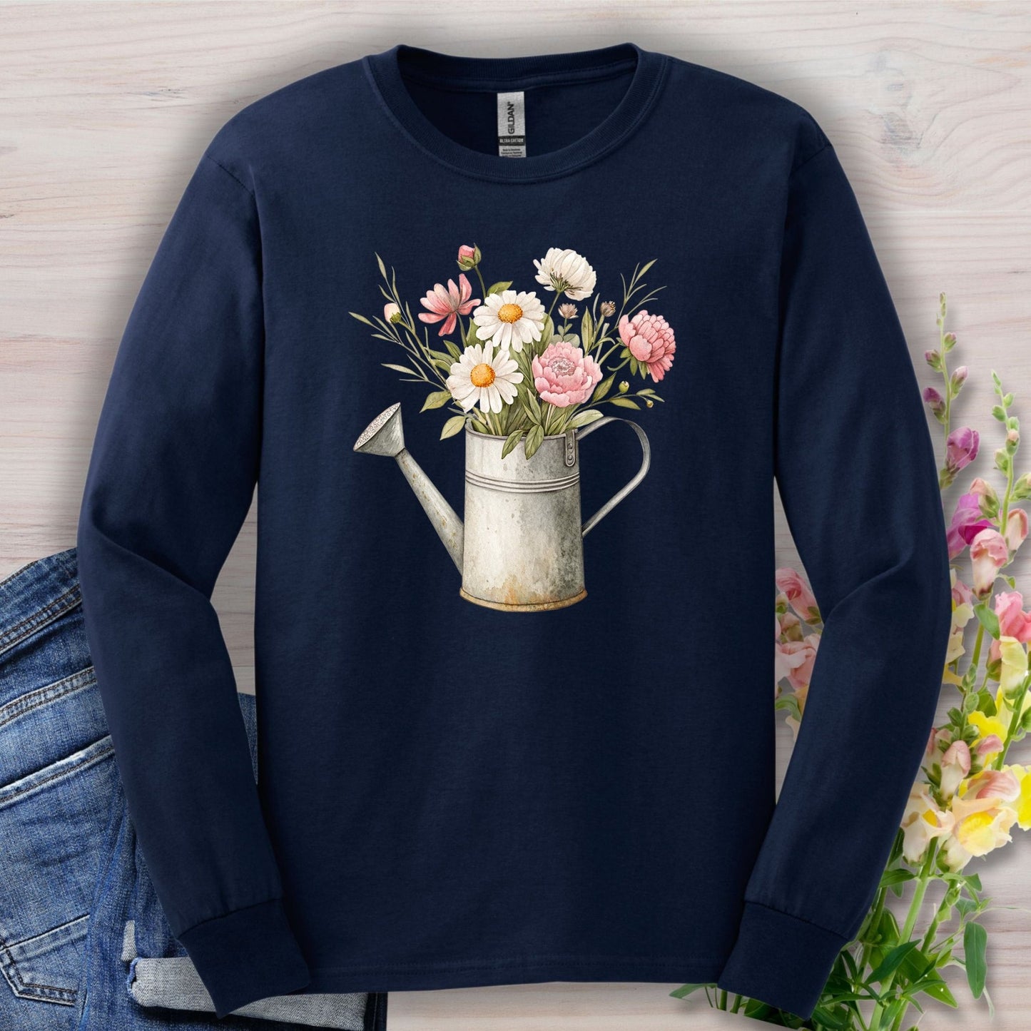 Navy long sleeve tee with a vintage watering can and botanical floral illustration.