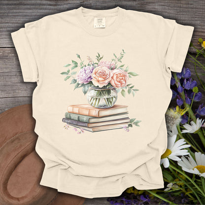 Ivory S t-shirt with a watercolor bouquet in a glass vase on vintage books.
