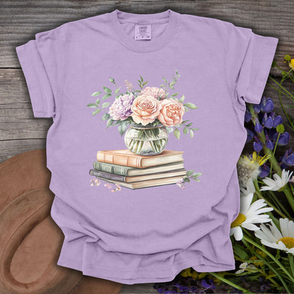 Orchid S t-shirt with a watercolor bouquet in a vase on vintage books, surrounded by wildflowers.