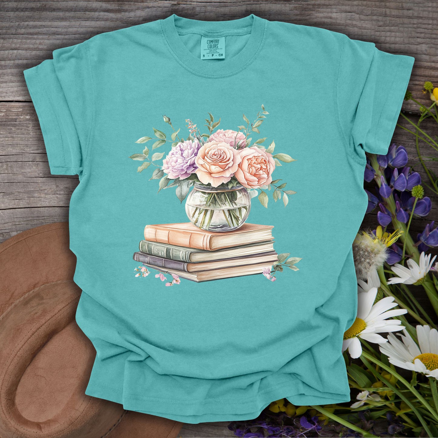 Seafoam S t-shirt with a watercolor pastel bouquet in a vase on vintage books.