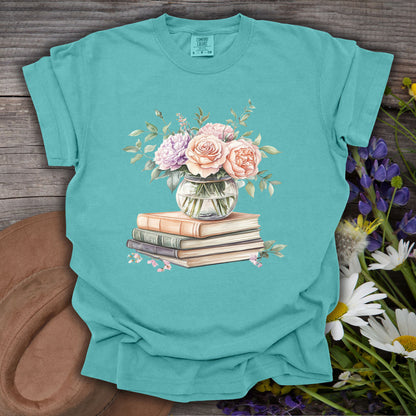 Seafoam S t-shirt with a watercolor pastel bouquet in a vase on vintage books.
