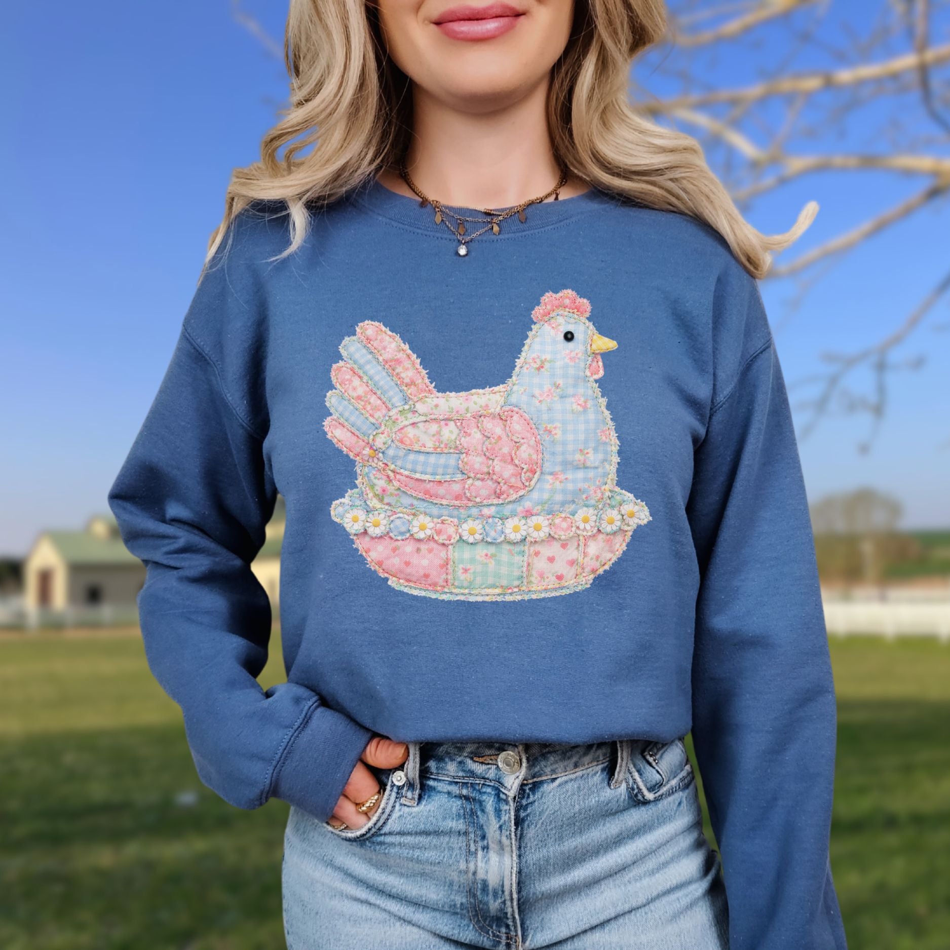 Blue unisex sweatshirt with a pastel faux patchwork hen design.