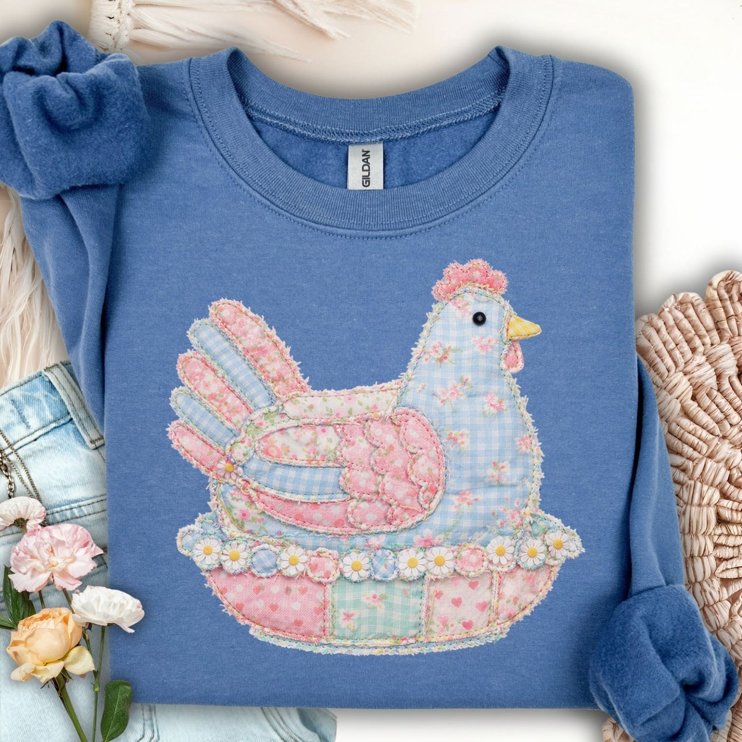 Indigo blue unisex sweatshirt with a pastel faux patchwork hen graphic.