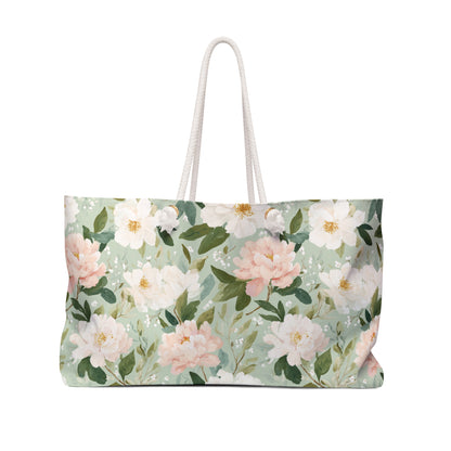 Mint green weekender bag with watercolor pink and white peonies, green leaves, and cream rope handles.