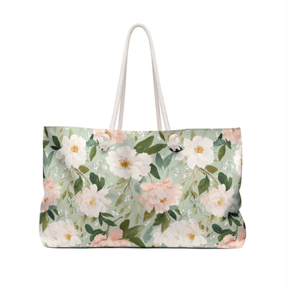 Mint green weekender bag with watercolor pink and white peonies, cream rope handles, and gold grommets.