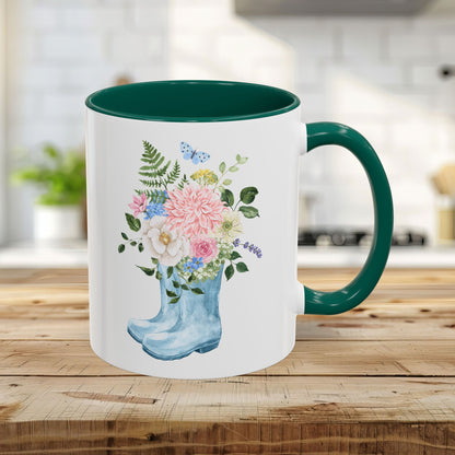 11oz glossy ceramic mug with a green handle and interior, featuring a watercolor rain boot and floral bouquet design.