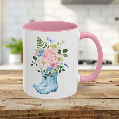 11oz glossy ceramic mug with pink handle/interior, featuring a watercolor rain boot with floral bouquet.