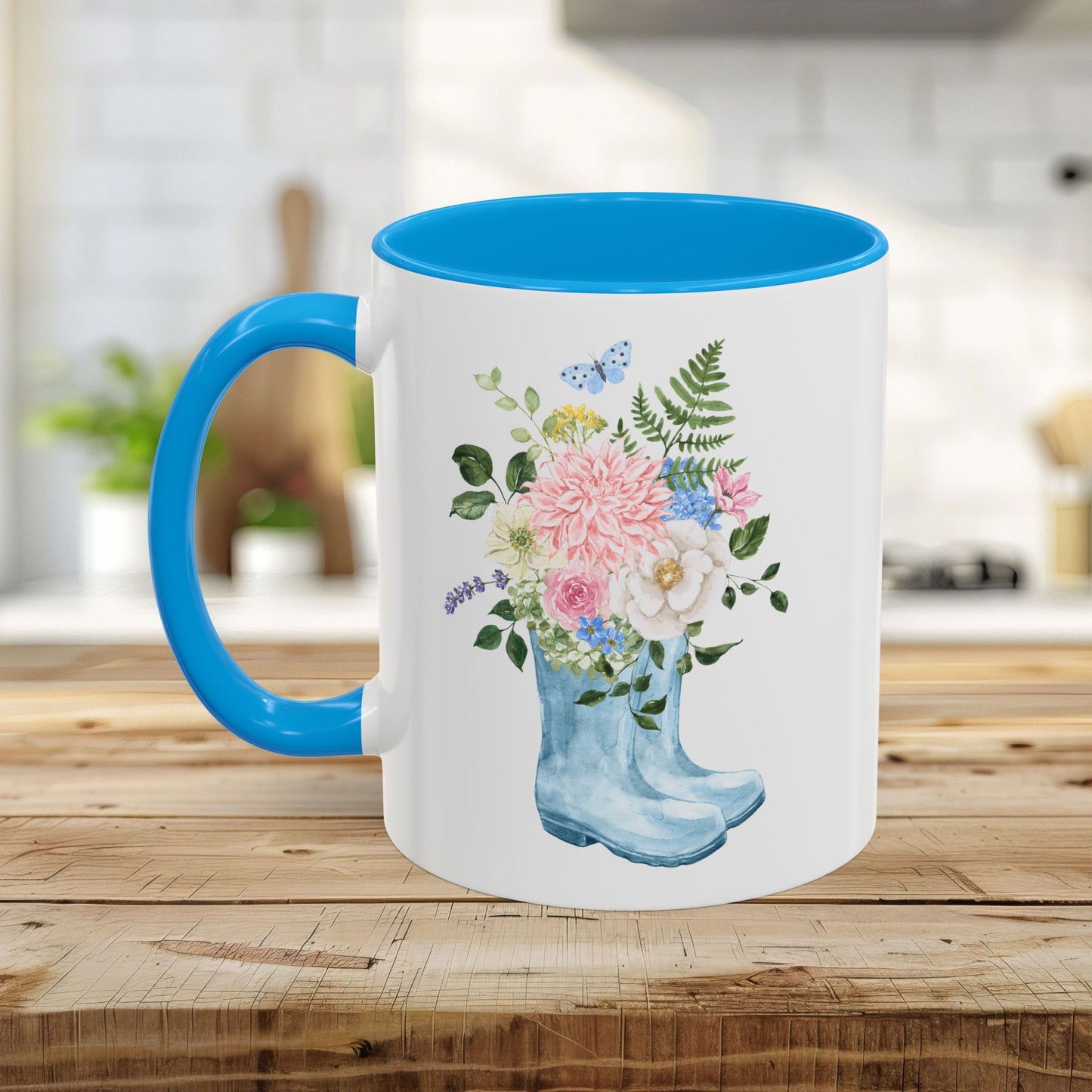 White ceramic mug with blue handle and interior, featuring a watercolor rain boot with a floral bouquet.
