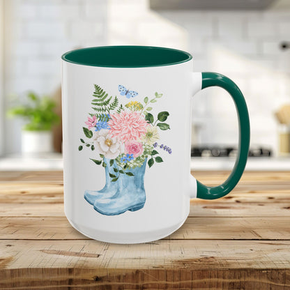 15oz glossy ceramic mug with a green handle and interior, featuring a watercolor rain boot with a floral bouquet.