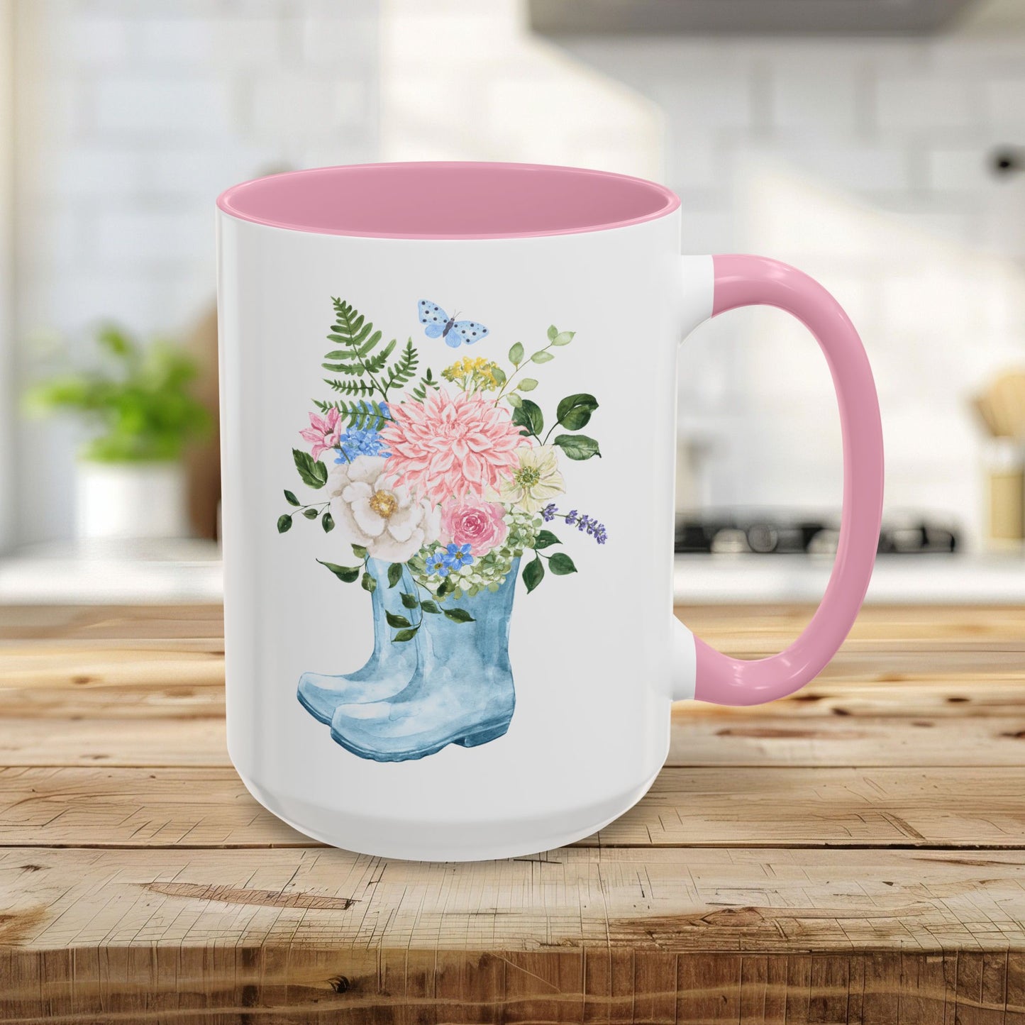15oz glossy ceramic mug with a pink handle and interior, featuring a watercolor rain boot with a floral bouquet.