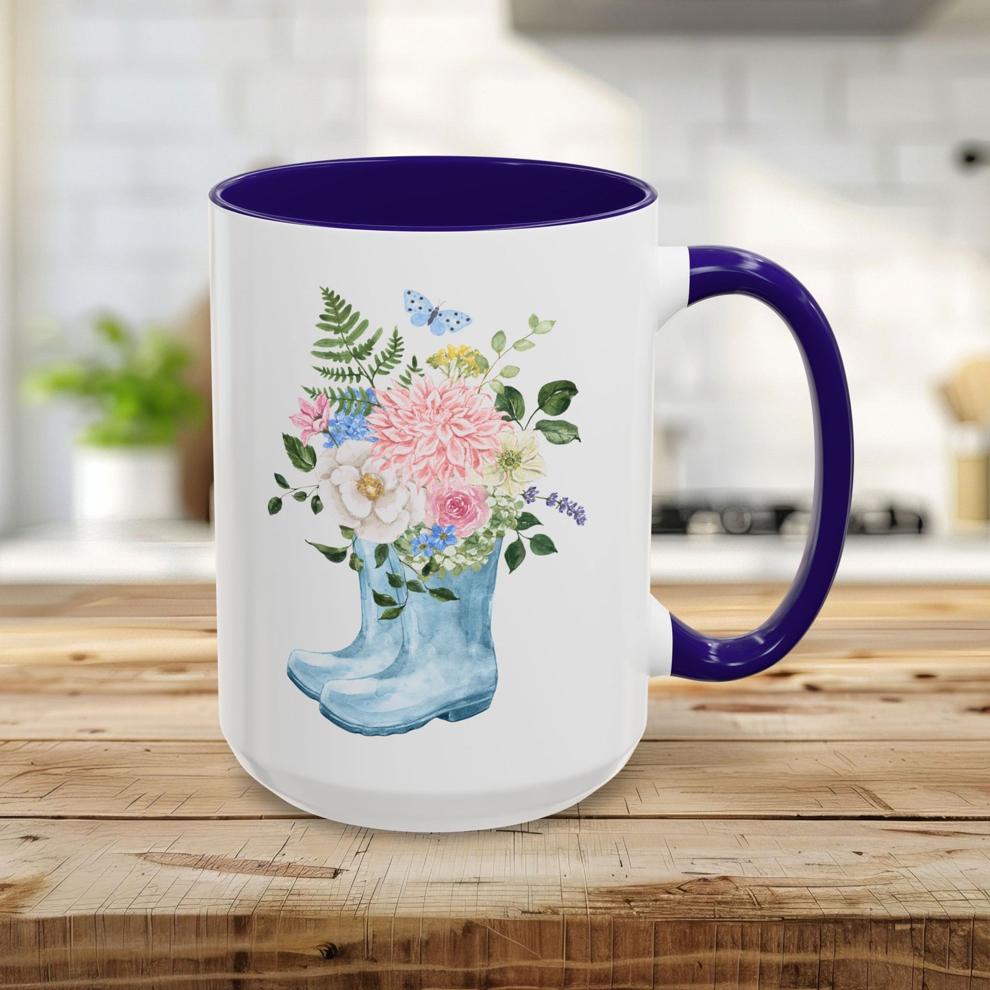 15oz glossy ceramic mug with a blue handle and interior, featuring a watercolor rain boot with a floral bouquet.